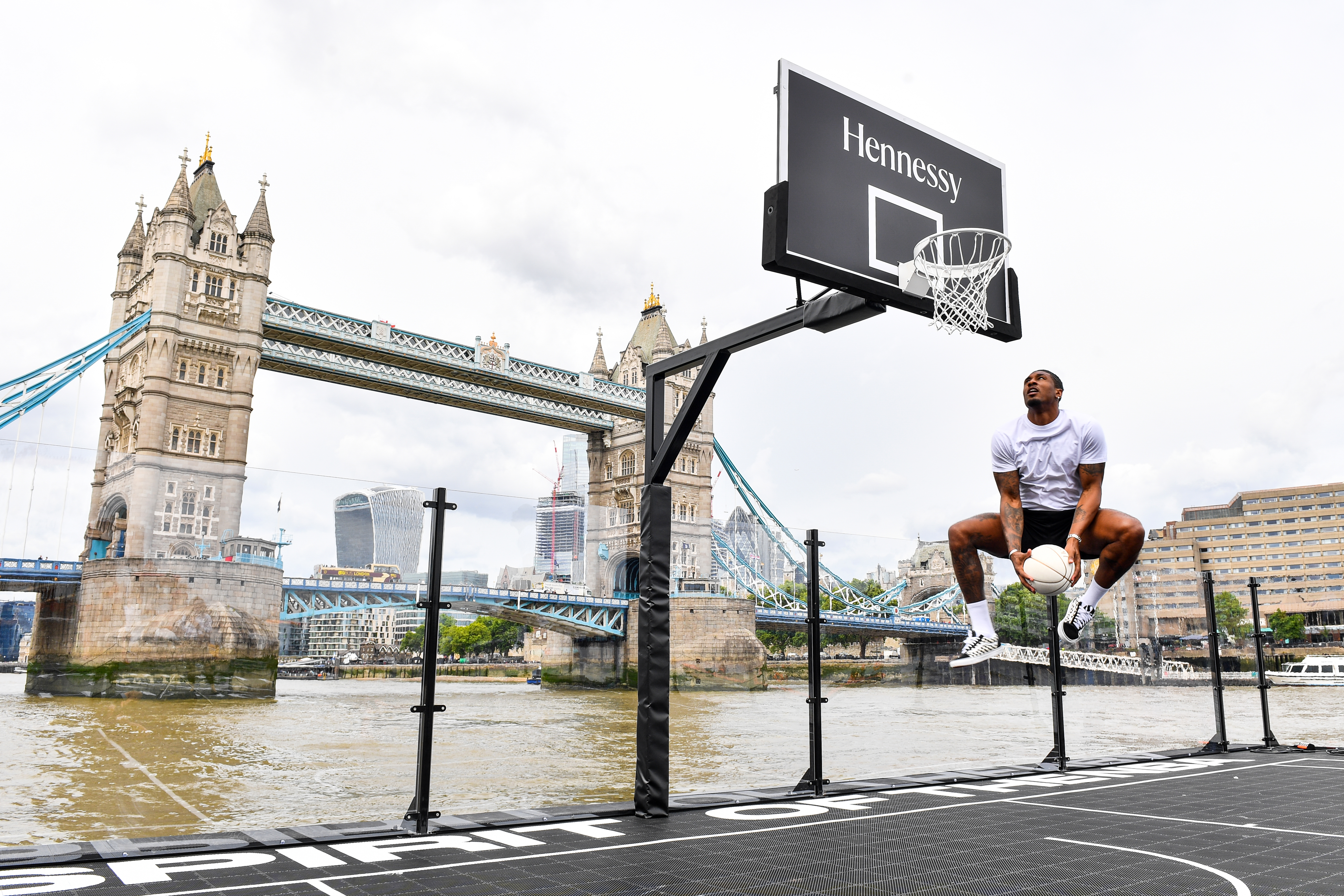 Watch AJ Tracey play on a floating basketball court for Hennessy x NBA